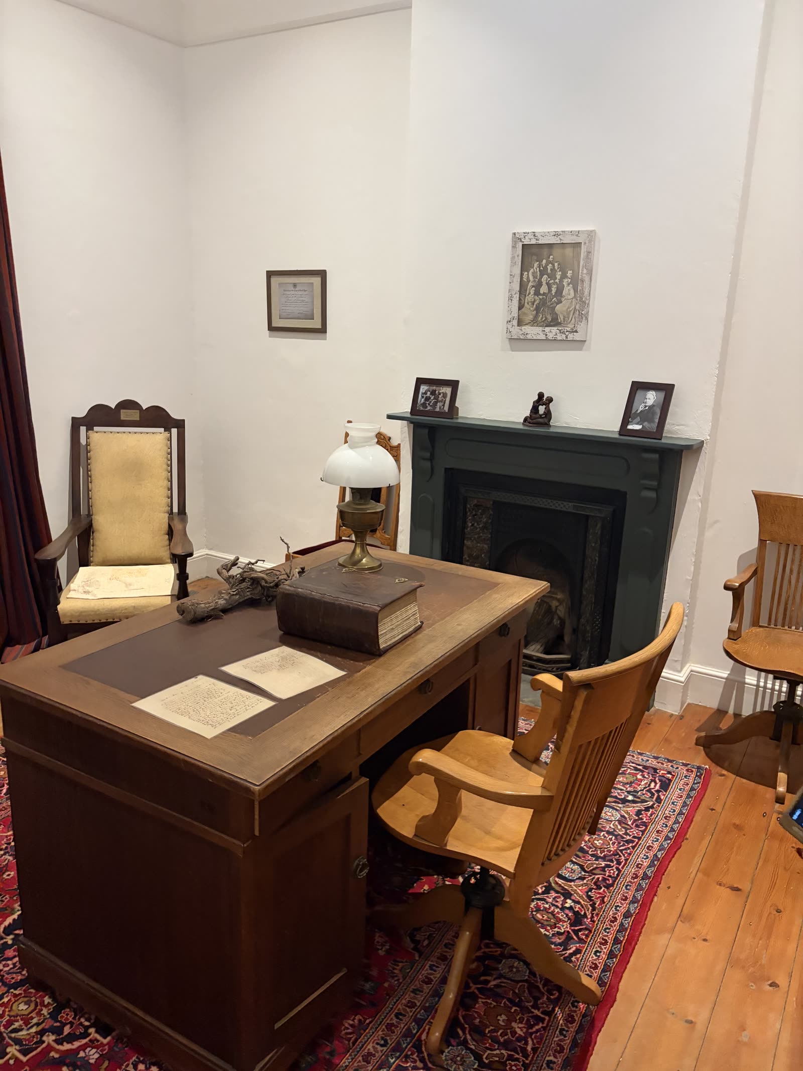 Andrew Murray's preserved study — his desk, oil lamp, and personal Bible, with family photographs on the mantel.